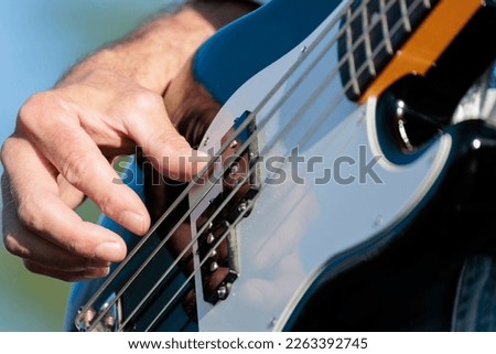 Similar – Image, Stock Photo Man with electric bass and bare feet on wooden bench on terrace in autumn