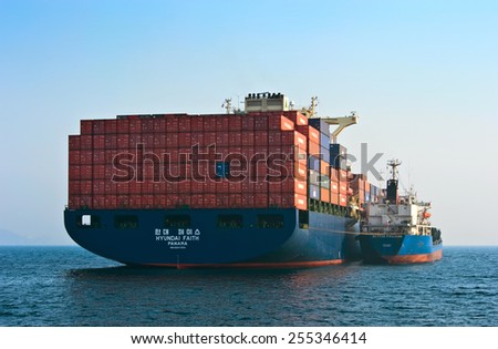 Bunkering tanker Russian Island container ship Hyundai company. Nakhodka Bay. East (Japan) Sea. 19.04.2014