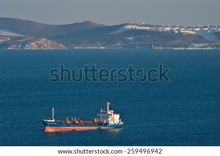 Russian Island tanker at anchor in the roads against the backdrop of the oil terminal. Nakhodka Bay. East (Japan) Sea. 05.03.2015