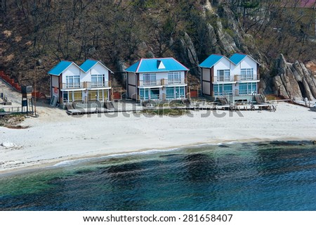 Wooden houses built on the coast. Far East of Russia. East (Japan) Sea.