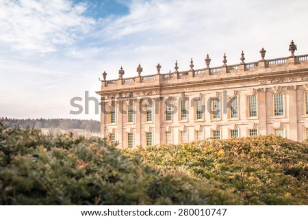 Bakewell, UK - April 2, 2015: Chatsworth House taken from the Garden in Bright Blue Sky. This Old European Style House is famous place for tourism and located in Peak District, Derbyshire.
