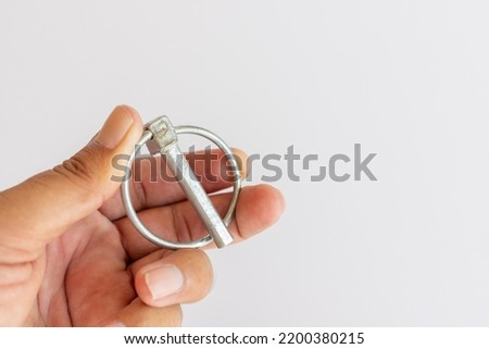 Lynch pin holding in hand on a white background with selective focus Foto stock © 