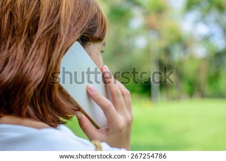 Women talk about business - close up of woman hands with cell phone.