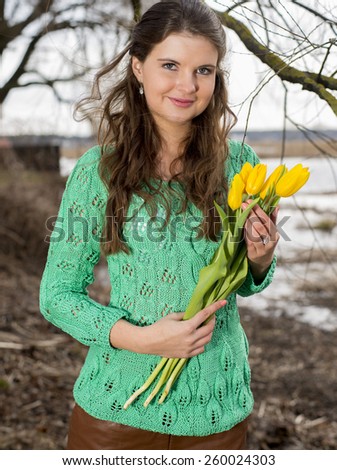 Women with yellow flowers smiling