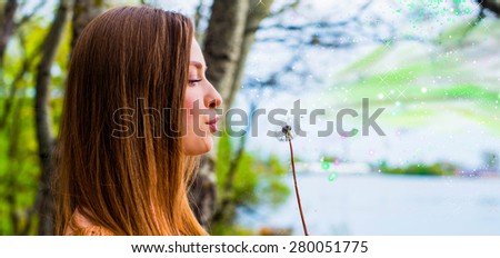 The woman blows on a dandelion, waiting for summer, Make the wish