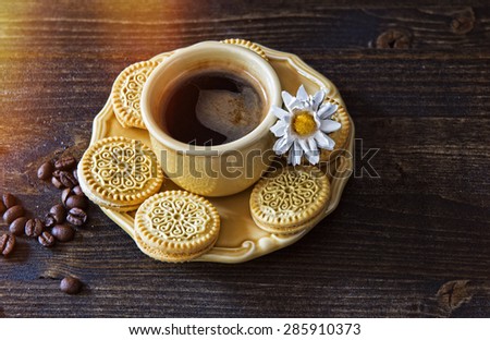 Summer coffee with cookies and a camomile on a wooden table