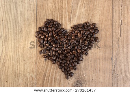 Broken Heart from coffee beans on wooden background.Heart attack.High pressure
