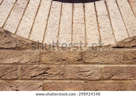 Background of brick wall texture with bright bricks laid in semicircle