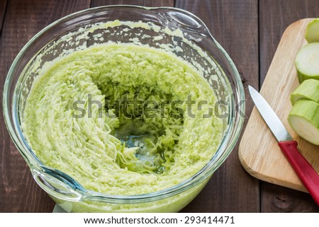 shredded zucchini in a bowl of a food processor