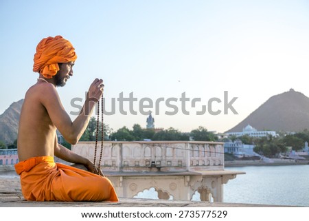 Pushkar, India-APRIL 20, 2015:Blessing of sadhu in Pushkar, India. Sadhu is a religious ascetic who is solely dedicated to achieving liberation from the world through meditation and contemplation