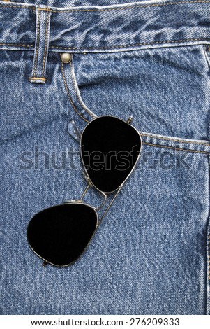 Sun glasses on a denim workers pocket