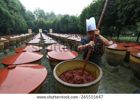 Pixian, Chengdu, Sichuan, China. September 24, 2015. Sichuan Spicy food, Chilli bean sauce is stirred up at the Sichuan Cuisine Museum. (Chilli bean sauce, Meticulously Brewed Douban, or Doubanjiang).
