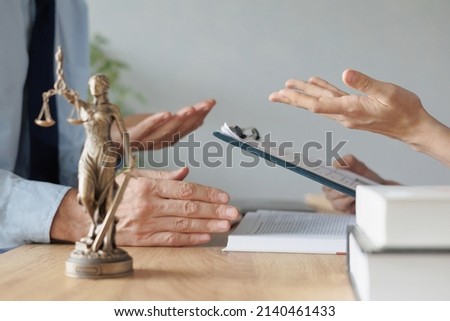 a female lawyer at a meeting with a male client in the office of the law office, legal advice online. resolution of disputes of the family code during divorce and division of property. work as a Photo stock © 