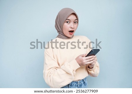 Similar – Image, Stock Photo Positive Muslim woman using smartphone on embankment