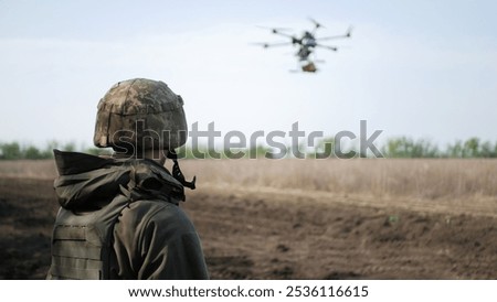 Similar – Foto Bild Soldat der ukrainischen Streitkräfte steht mit einer blau-gelben Flagge der Ukraine auf schwarzem Hintergrund