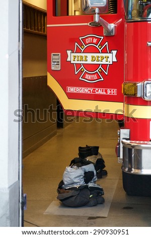 SEATTLE - JUNE 24, 2015 - Open door of a Seattle Fire Dept. truck with two sets of boots ready to be put on, showing the department is ready at a moments notice to respond to an emergency.
