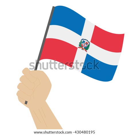 Hand holding and raising the national flag of Dominican Republic