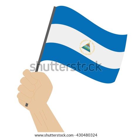 Hand holding and raising the national flag of Nicaragua