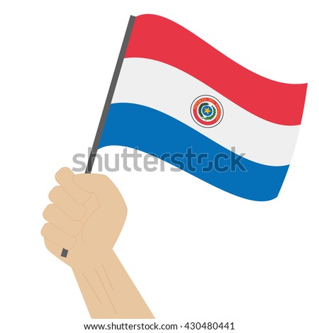 Hand holding and raising the national flag of Paraguay