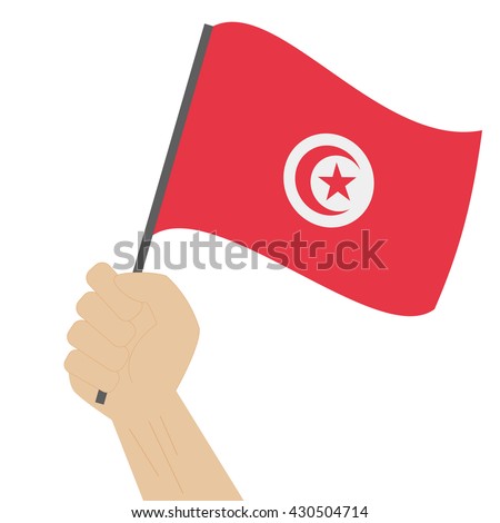 Hand holding and raising the national flag of Tunisia