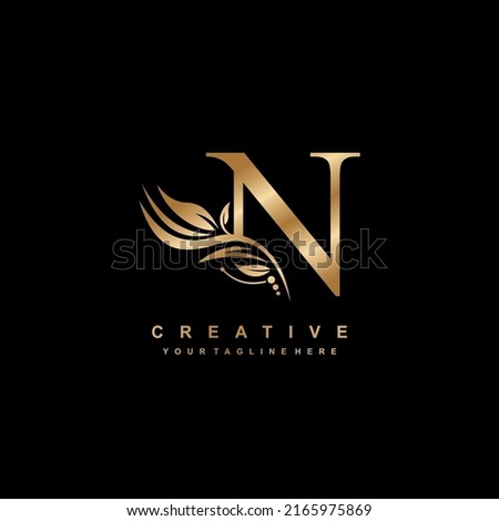 gold letter N logo design with luxurious and beautiful leaf ornament. N Monogram. N typography. gold feather logo. initial letter N logo