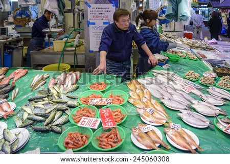 Kanazawa, Japan - April 14, 2014: A fish vendor in Omicho Market. Omicho Ichiba has been Kanazawa\'s largest fresh food market since the Edo Period. Today, it is a busy network of covered streets.