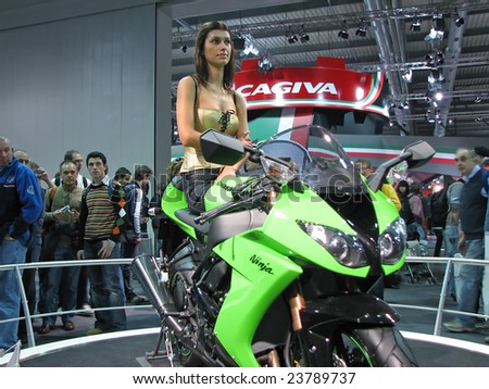 MILAN - NOVEMBER 10: Fashion model posing on a Kawasaki Ninja ZX-10R motorcycle in EICMA Show on November 10, 2007 in Milan, Italy.