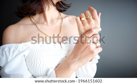 Woman Jewelery concept. Woman’s hands close up wearing rings and necklace modern accessories elegant life style with copy space for text and background.  Imagine de stoc © 