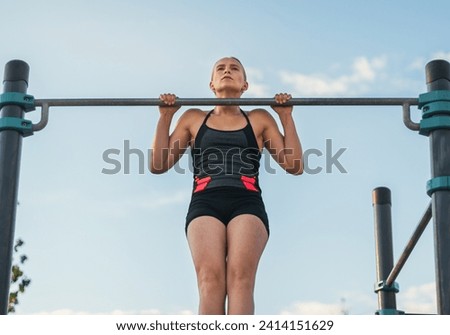 Similar – Image, Stock Photo Female athlete doing pull up exercises