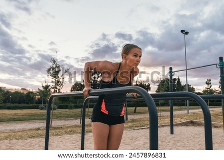 Similar – Image, Stock Photo Athletic woman doing triceps push-ups with a barbell plate