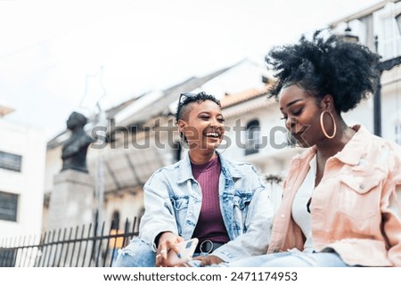 Similar – Image, Stock Photo Cheerful black woman talking on smartphone near sea in sunset