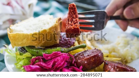 Grill sausages meat with vegetables and rice in a cafe in Istanbul