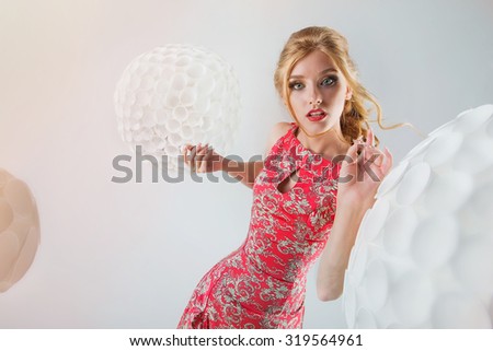 Model with beautiful make-up in the studio on a white background with white balls