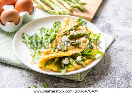Gourmet Tasty Egg Omelette with Asparagus and soft Cheese. Asparagus. Fresh Asparagus with eggs. Сток-фото © 