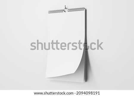 hanging blank clay white vertical wall wire bound calendar realistic mockup perspective view with flipping pages 3d rendering 3d illustration Foto d'archivio © 