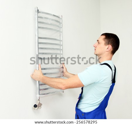 Plumber hanging towel rail