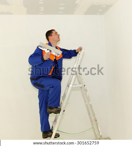 Plasterer with ladder in the room