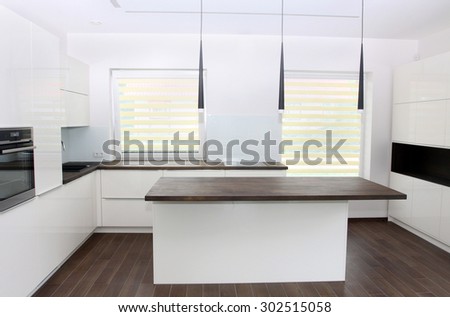 Modern white kitchen with solid wood tabletops