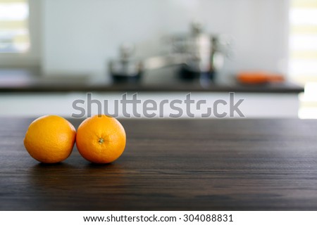 Fresh oranges on wooden tabletop in the kitchen