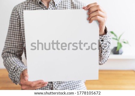 Similar – Image, Stock Photo Man holding vinyl record. Vintage music style. Rock style. Male wearing black jacket holding black disc standing on dark background. Retro music