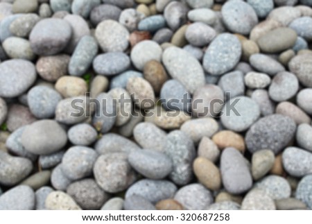 De focused/ Blurred image of round stones. Stone background.