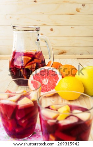 Jug of homemade delicious red sangria with limes oranges, apples and grapefruits
