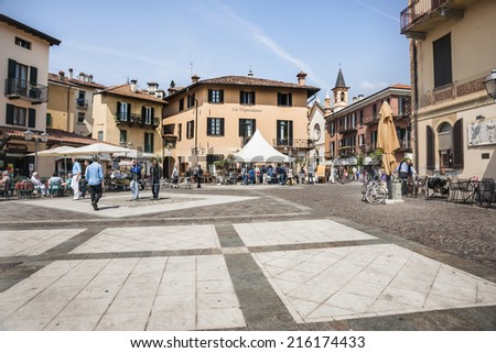 MENAGGIO, ITALY - MAY 7; Typically Italian village square on a nice day as people go about village life on May 7, 2011 in Menaggio, Italy