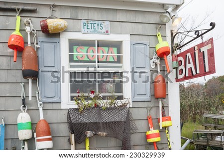 RYE HARBOR, USA,- OCTOBER 1; Bait shop sign hangs from wall with hanging fishing buoys decorating the exterior of shop on October 1, 2014 in Rye Harbor, USA.
