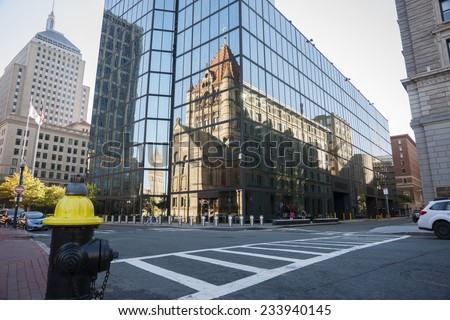 BOSTON, USA - OCTOBER 13; Urban reflections, Urban mirror image, Victorian style cathedral reflected  reflected in mirror glass facade of modern building.on October 13, 2014 in Boston, USA
