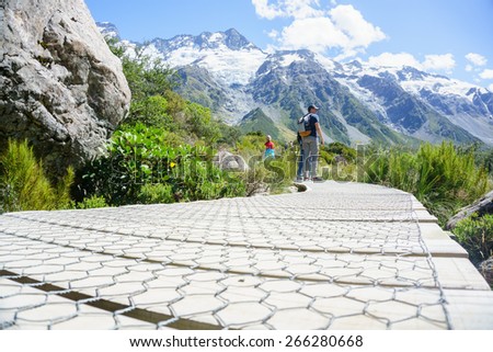 MOUNT COOK, NEW ZEALAND - February 16; People hiking, pausing to observe the natural beauty on one of the great New Zealand walks February 16,2015 at Mount Cook, New Zealand. Hookers Track