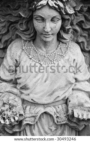 Old Female statue with hands stretched out in front of her