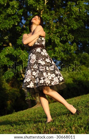 Happy looking young woman wearing a floral print dress
