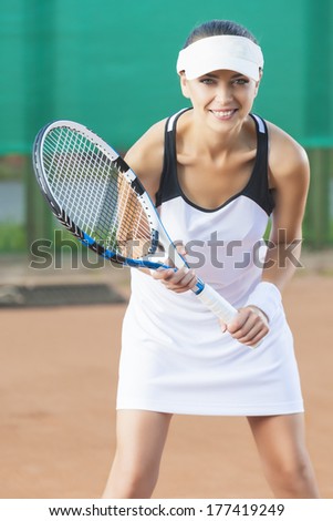 Female tennis Player Ready To Serve Ball At Court. Vertical Image