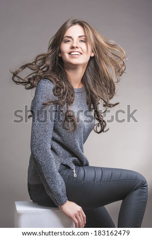 Portrait of Pretty Caucasian Brunette Woman Smiling. Over Gray Background. Vertical Orientation